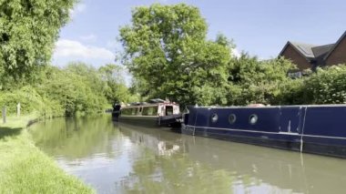 A beautiful view of boats on the river on the big house background in the Rugby, UK