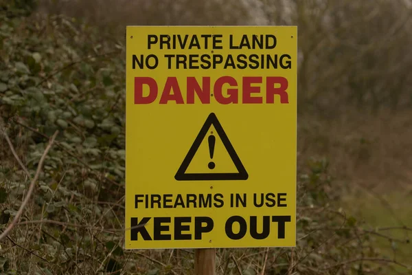 Private Land Yellow Warning Sign Showing Danger Firearms Use Trespassing — Stock Photo, Image
