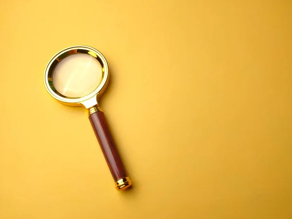 Closeup Vintage Brass Color Magnifying Glass Isolated Yellow Background — Stock Photo, Image