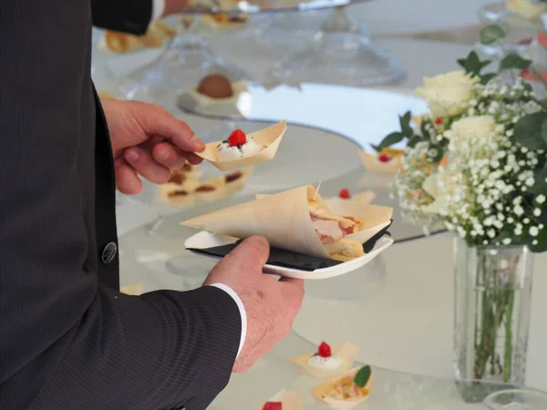 テーブルからデザートを取る手のクローズアップ — ストック写真