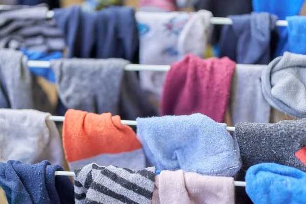 A closeup of washed clothes drying on racks