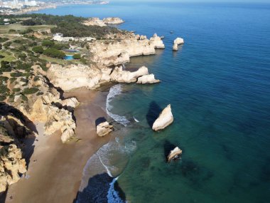 An aerial view of Marinha beach surrounded by rocks in Algarve