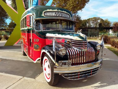 old red Chevrolet 1946 bus for public passenger transport in Buenos Aires. Traditional fileteado ornaments. Line 109. Front view. Classic car show.