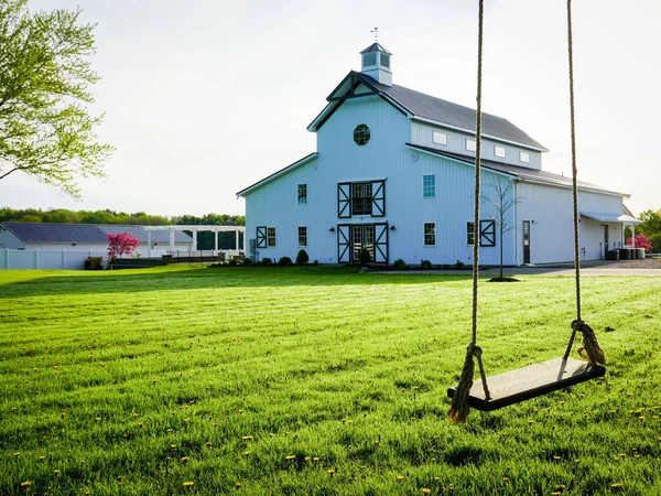 The Barn at Hart's Grove in the countryside with a rope swing at sunrise