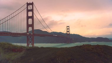 A sunset view of the Golden Gate Bridge, a suspension bridge from the Marin Headlands, San Francisco, California