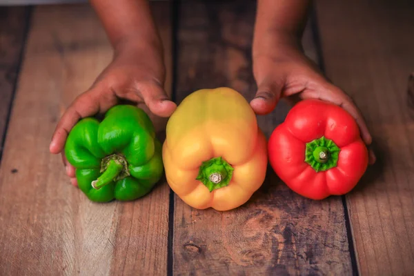 bel peppers capsicum on a wooden tab