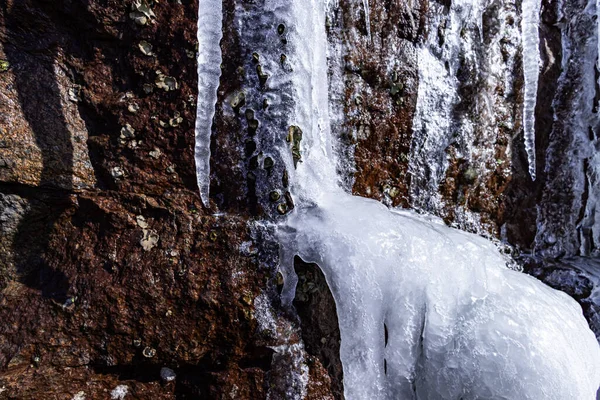 Closeup Shot Frozen Waterfall Icicles Brown Rock Surface — Stock Photo, Image