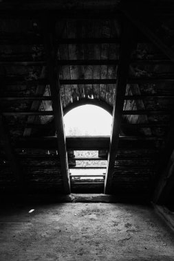 Terk edilmiş psikiyatri bölümü binasının iç kısmının dikey gri tonlu görüntüsü.