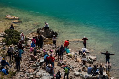 The tourists at Humantay Lake near Salkantay peak in Peru
