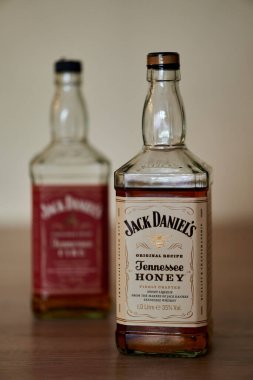 The bottles of Jack Daniels Tennessee Honey whiskey bottle on a table