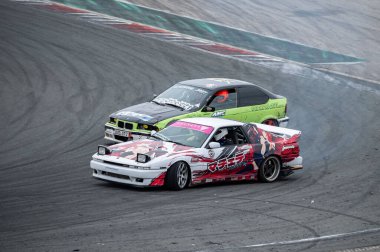 Beyaz giysili Supra, sürüklenmeye hazır bir A70 mk3.