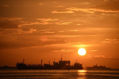 A golden sunset sky background over the ships in the lake