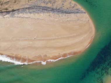 The bird's eye view of the beach with the greenish sea. Valdearenas, Cantabria.
