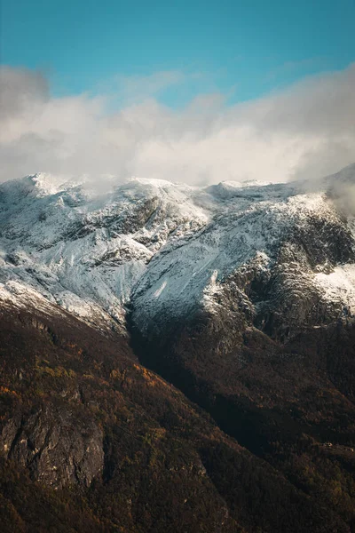 Eine Vertikale Aufnahme Der Schneebedeckten Berge Gegen Den Blauen Himmel — Stockfoto