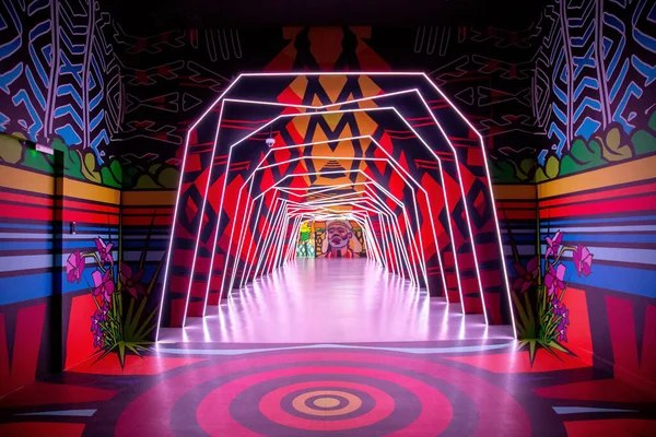 pink and red artwork with light tunnel