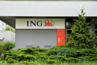 The exterior of an ING bank office surrounded by lush plants