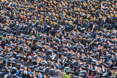 An aerial view of a crew of students in graduation caps