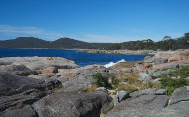 An beautiful view of waves splashing against the Bay of Fires in Australia