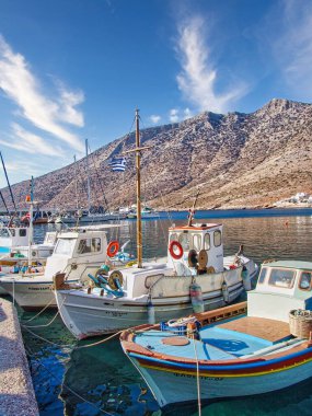 A vertical shot of a beach with sailing boats in Kameras village, Sifnos island, Greece