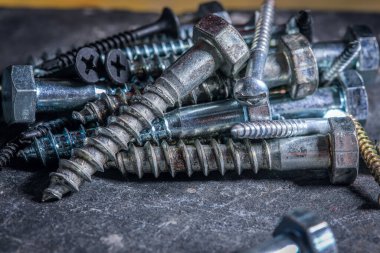 A closeup shot of screws on a table in a workshop