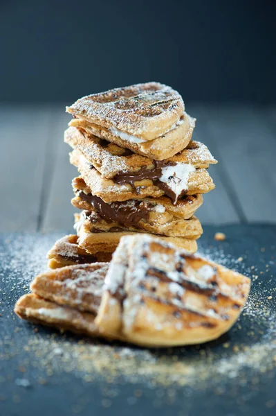 A stack of waffle S\'mores with chocolate and marshmallow.
