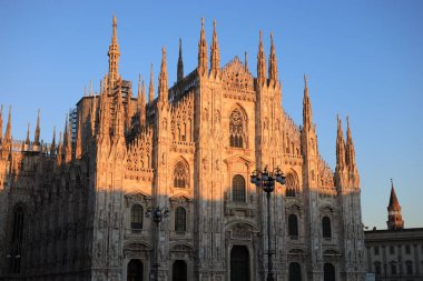The historic Duomo Cathedral under a sunset sky in Milan, Italy