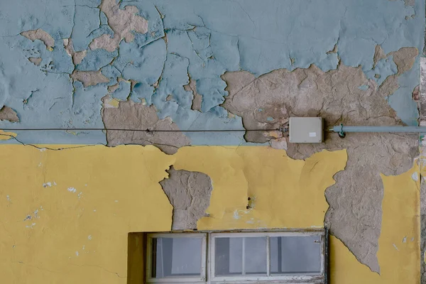 The blue and yellow colors of the Ukrainian flag painted on the old, worn walls of a building in Bratislava