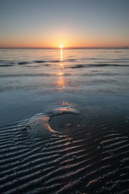 A vertical shot of the Sunrise at Nudgee Beach, Budge, Brisbane, Queensland Australia