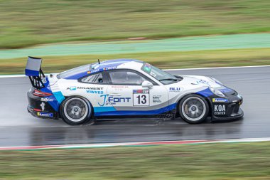 Gerracing car in the wet track, raining day. Porsche 911 Cup my 2018