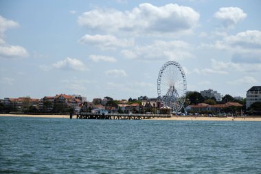 A beautiful view of a Ferris wheel on the coast of Arcachon town in France