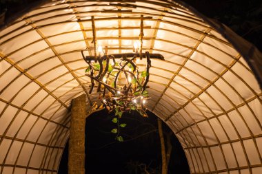 A closeup of a lamp made of tree branches