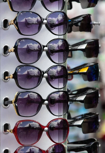 Many sunglasses on display for sale, market, female mode