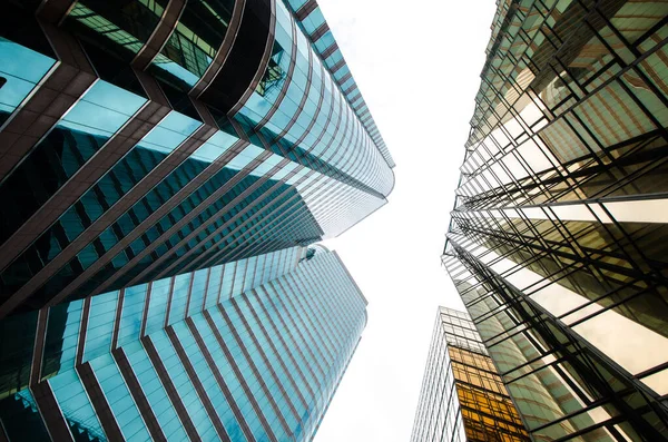 A skyscrapers photographed from below with a sky in Hong Kong