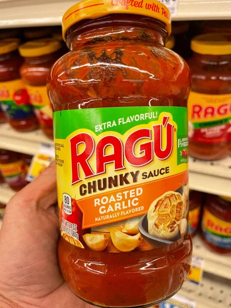 Columbia County, Ga USA - 04 22 22: Hand holding a jar of Ragu spaghetti sauce