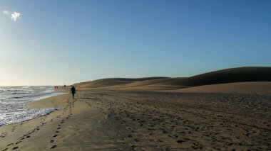 The Maspalomas Dunes with people walking and leaving foot trail on Gran Canaria, Canary Islands, Spain