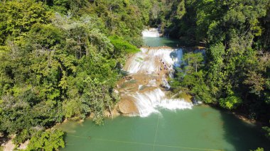 A drone shot of Waterfall of Roberto Barrios in Palenque Chiapas park on a sunny day