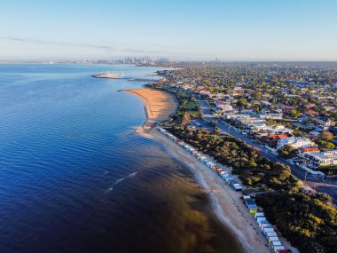 Brighton beach boxes and Melbourne skyline at sunrise