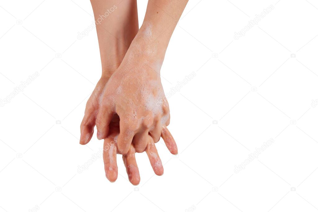 A woman clasping hands and spreading soap between fingers against white background