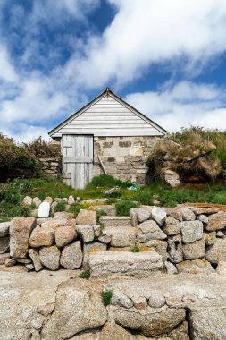 A vertical shot of a small fisherman's hut on the Isles of Scilly, Cornwall