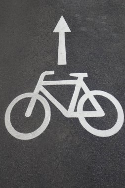 A vertical shot of a bicycle sign on the ground in the street in Germany