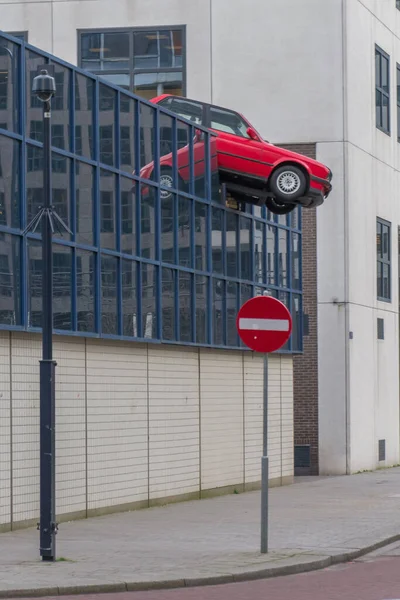 Vertical Shot Sculpture Red Car Stuck Glass Fence Rotterdam Netherlands —  Fotos de Stock