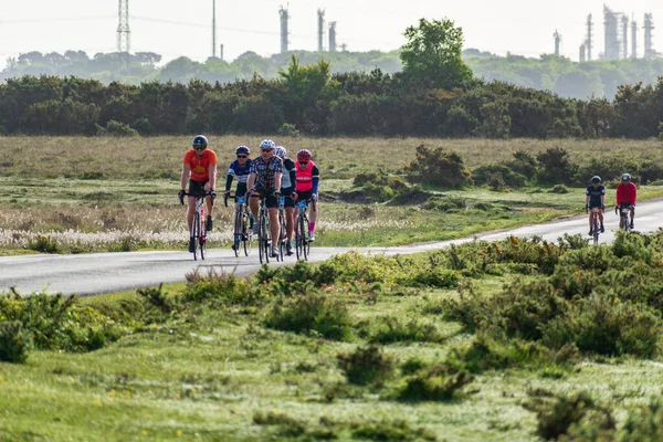 Cyklisterna Rider Längs Öppen Landsväg Med Träd Och Kraftledningar Bakgrunden — Stockfoto