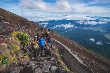 A Japan -Tourists descend from Mount Fuji along the Yoshida trail.