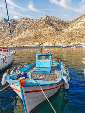 A vertical shot of a beach with sailing boats in Kameras village, Sifnos island, Greece