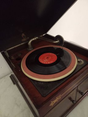 A vertical shot of a Lokananta record playing on a vintage vinyl record player