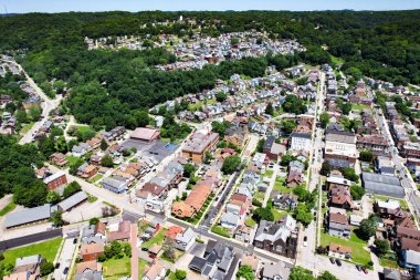 The bird's eye view of the residential area surrounded by green vegetation. Pittsburgh, Pennsylvania.