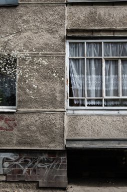 A vertical shot of the facade details of an old residential building