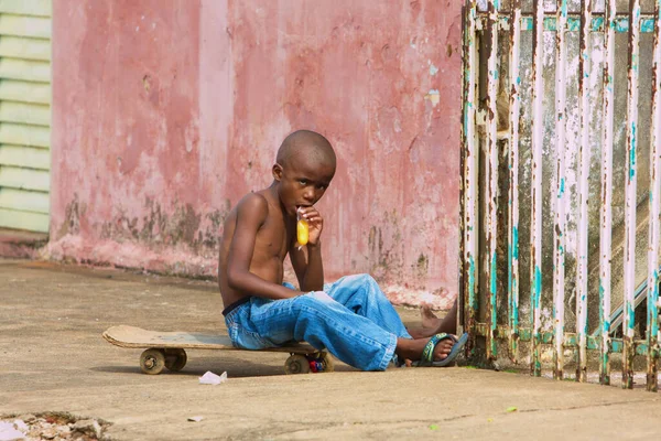 Adorable Young Black Boy Enjoying Snack While Sitting His Skateboard — Stock Photo, Image