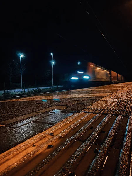 A scenic shot of a train in a long exposure motion during the night