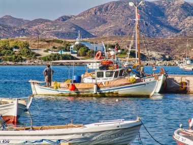 A beautiful shot of boats in the sea at Pollonia village in Milos island, with nice beach and mountains